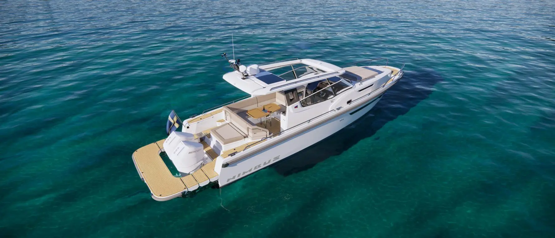 A sleek motorboat anchored on clear turquoise water, showcasing a spacious deck with seating and a central table.